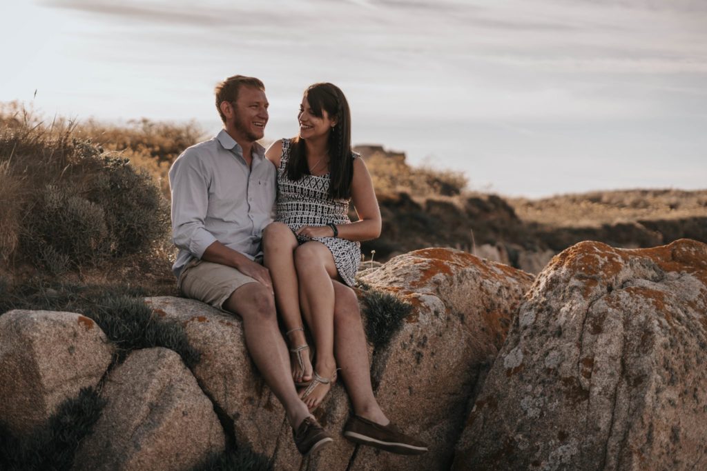 couple having a laugh on their engagement session in Grandes Rocques