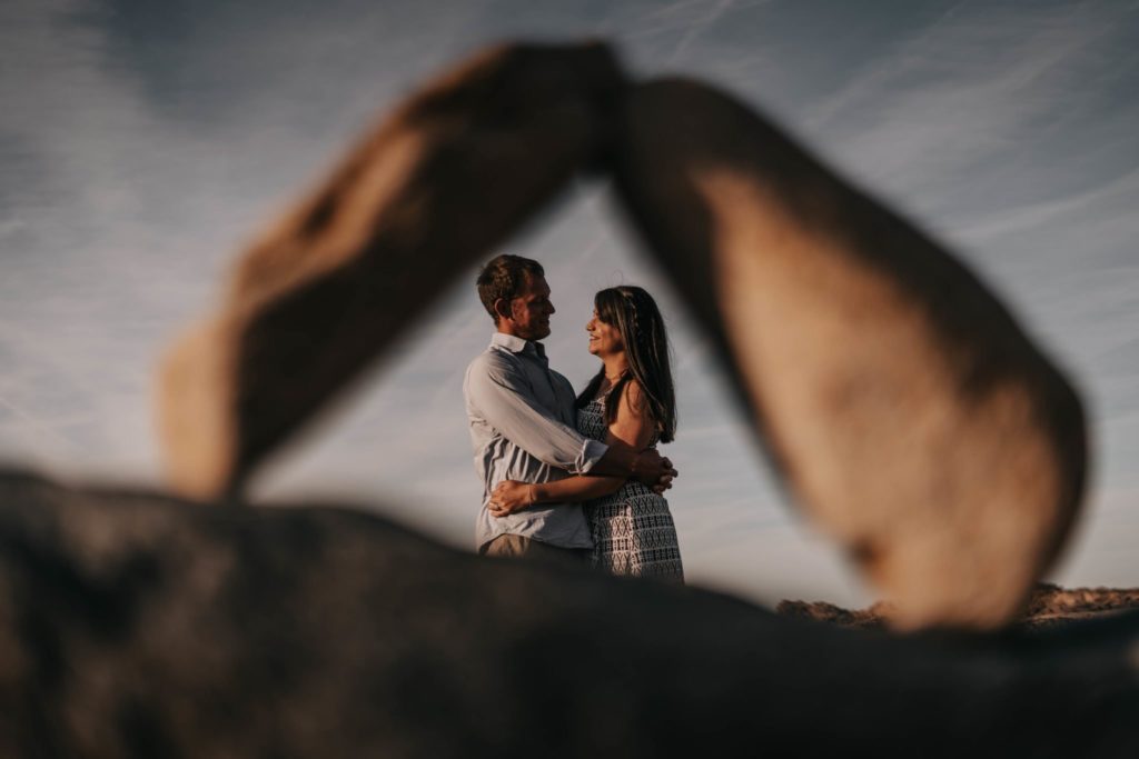 Couple hugging during their engagement session in Guernsey