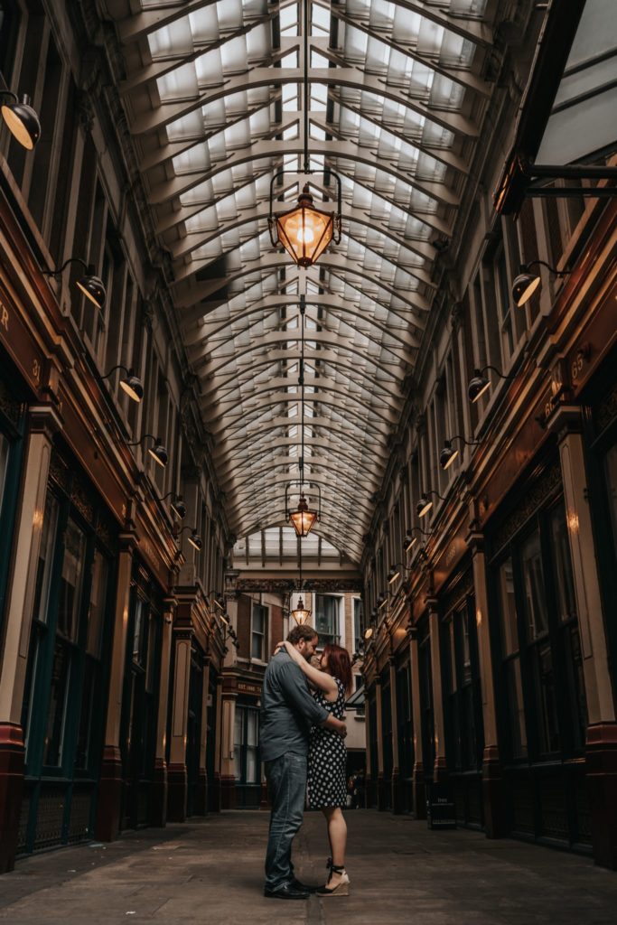 couple hugging under the arches of Leadenhall market