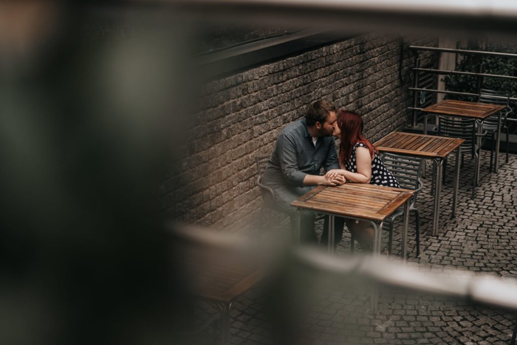 couple having a kiss in a cafe in London
