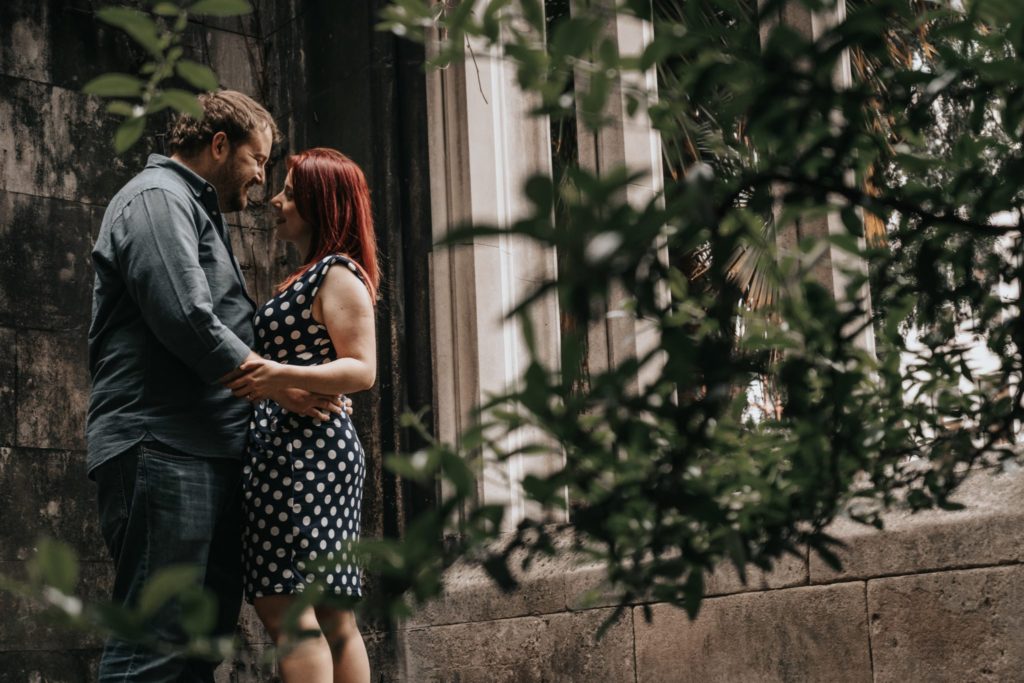 bride to be and groom to be embracing one another