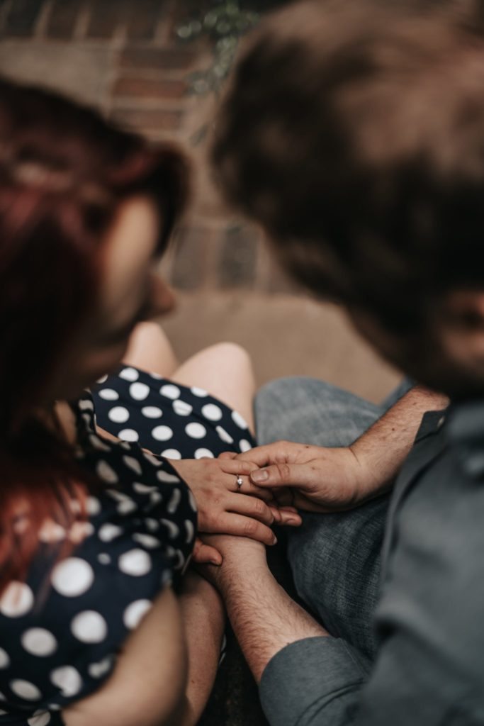 groom to be looking at his fiancee's engagement ring