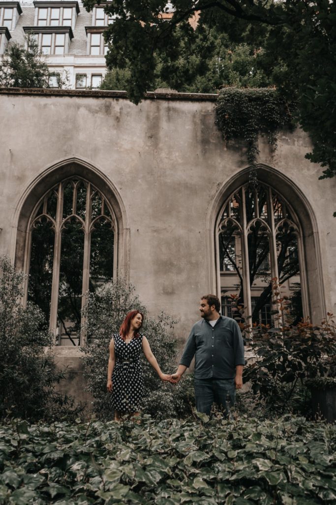 couple holding hands in abandonned church in London