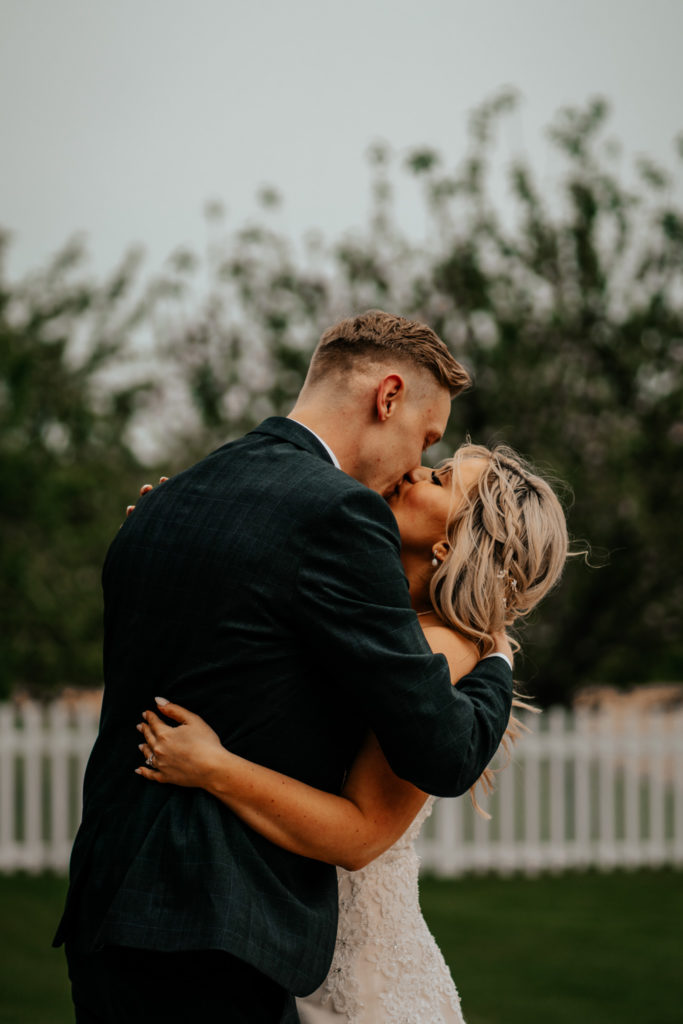 Bride and groom kissing at Villiers Barn