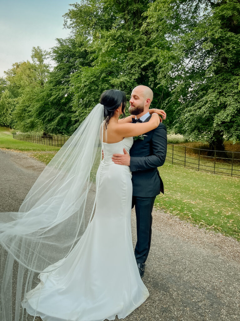 Bride’s veil flowing in the wind at Braxted Park wedding