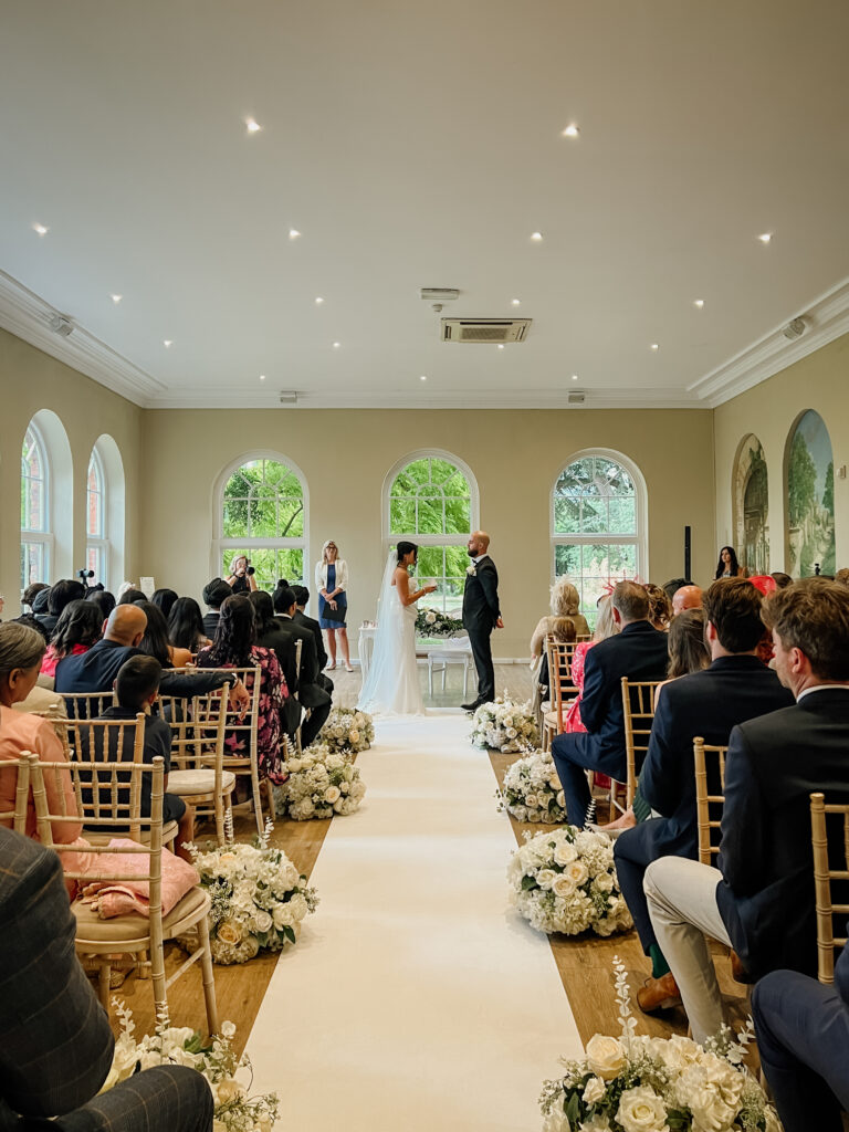 Candid ceremony moment in the Orangery at Braxted Park